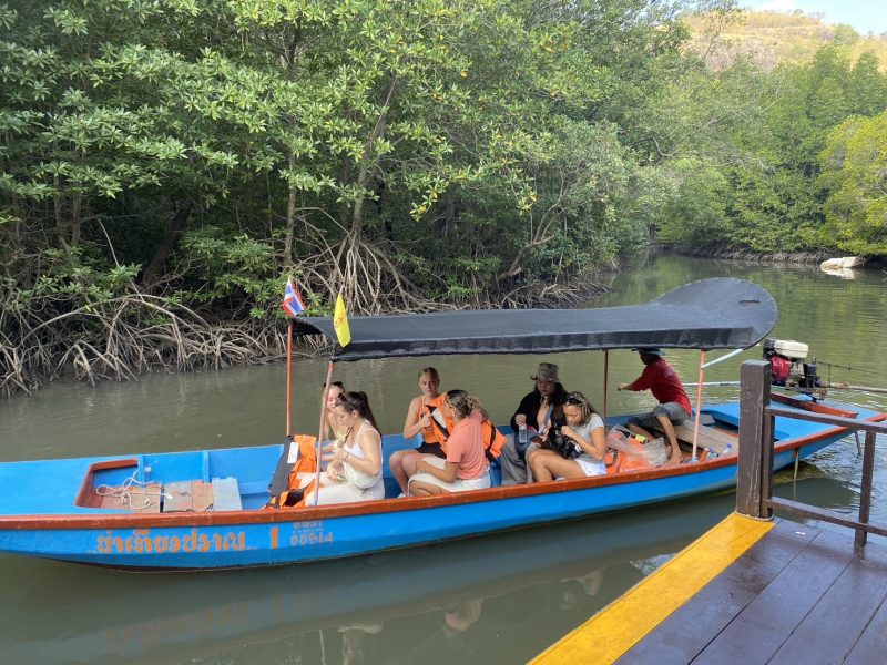 River boat trip in Thailand with tourists in boat
