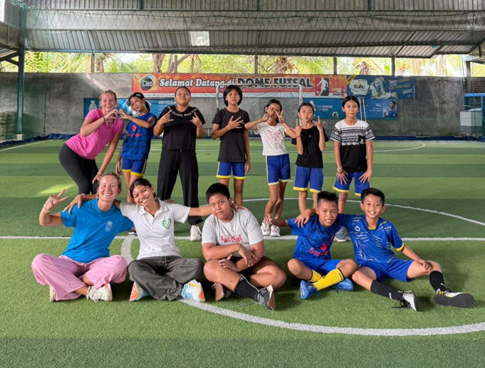 Group of sports kids on indoor sports field