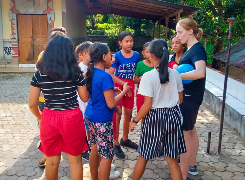 Sports volunteer girl coaching girls netball in Bali